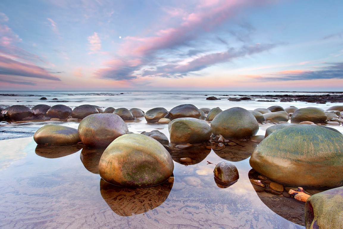 These sandstone concretions at Bowling Ball Beach, a few miles south of Point Arena, California are much like the Moeraki boulders in New Zealand. This is low tide at sunrise, which is good for reflections.